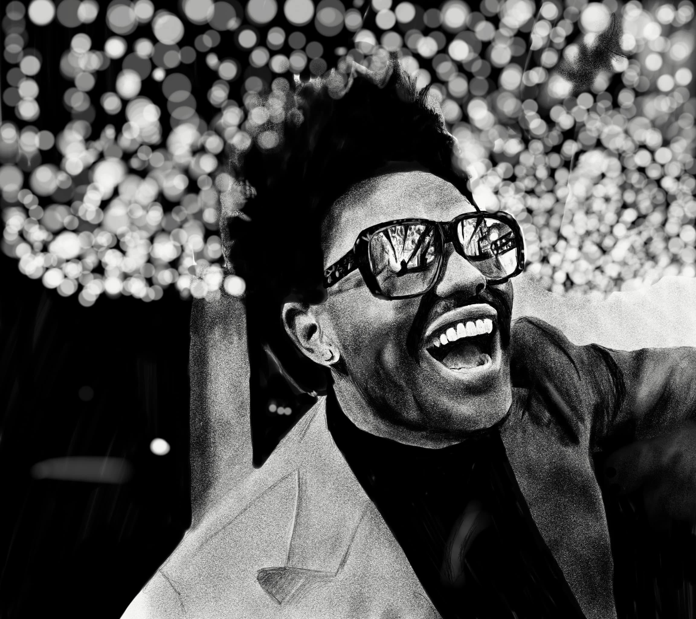 Black and white portrait of a man laughing in sunglasses against a blurred bokeh background.
